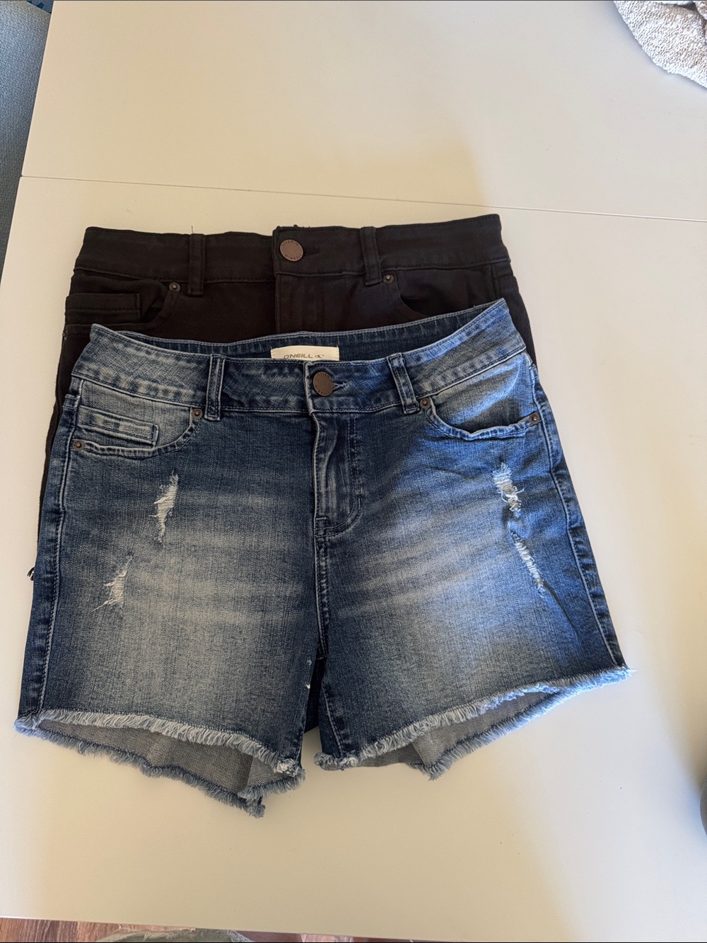Two pair size 27 O'Neill Women's Frayed Hem Denim Shorts - Blue & Black